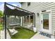 Inviting backyard patio with covered pergola, comfortable seating, and a lush garden, creating an ideal outdoor retreat at 1450 Crescent Walk, Decatur, GA 30033