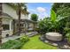Secluded backyard featuring a deck with a pergola, swing, hot tub, and lush tropical foliage, offering privacy at 1450 Crescent Walk, Decatur, GA 30033