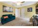 Cozy bedroom with a green sofa, carpet floors, a ceiling fan, and bright yellow walls at 1450 Crescent Walk, Decatur, GA 30033
