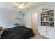 Cozy bedroom with carpet and a ceiling fan, decorated with books and a playful, modern theme at 1450 Crescent Walk, Decatur, GA 30033