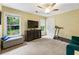 Bedroom featuring a ceiling fan, TV, and a treadmill for exercise, illuminated by natural light from two windows at 1450 Crescent Walk, Decatur, GA 30033