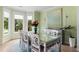 Elegant dining room with bay windows, a glass-topped table, and seating for six at 1450 Crescent Walk, Decatur, GA 30033