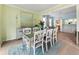 Charming dining room open to the living room, featuring a stylish table and bright green walls at 1450 Crescent Walk, Decatur, GA 30033