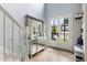 Bright foyer with hardwood floors, a mirrored console table, and a staircase leading to the upper level at 1450 Crescent Walk, Decatur, GA 30033
