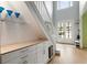 Bright foyer featuring built-in storage under the stairs and a light-filled entry with double doors at 1450 Crescent Walk, Decatur, GA 30033