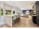 Modern kitchen and living area with an island, stainless steel appliances, and lots of natural light at 1450 Crescent Walk, Decatur, GA 30033