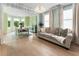 Open-concept living and dining area with light hardwood floors, large windows, and stylish decor at 1450 Crescent Walk, Decatur, GA 30033
