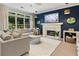 Bright and stylish living room with a fireplace, modern decor, and large windows overlooking the yard at 1450 Crescent Walk, Decatur, GA 30033