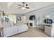 Spacious bedroom featuring a fireplace, a ceiling fan, and carpet flooring throughout the room at 1450 Crescent Walk, Decatur, GA 30033