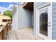 This outdoor porch features wood flooring, light blue siding, and entrance into the house at 1797 Olive Se St, Atlanta, GA 30315