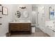 Modern bathroom featuring a double vanity, wood-look tile flooring, and a glass-enclosed shower at 1797 Olive Se St, Atlanta, GA 30315