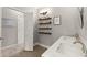 Bathroom with a double sink vanity, wood-look tile floors, and decorative shelving at 1797 Olive Se St, Atlanta, GA 30315