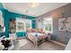 Vibrant bedroom featuring blue walls, plush carpet, and ample natural light at 1797 Olive Se St, Atlanta, GA 30315