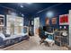 This carpeted bedroom features blue walls, a bed, desk, TV, and sports posters on the wall at 1797 Olive Se St, Atlanta, GA 30315