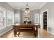 Bright dining room featuring a large wooden table, pendant lighting, and ample natural light at 1797 Olive Se St, Atlanta, GA 30315
