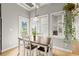 Bright dining area featuring a wood table, white chairs, and ample natural light from the large windows at 1797 Olive Se St, Atlanta, GA 30315