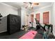 This exercise room features an exercise bike, treadmill, wood blinds, and rubber flooring at 1797 Olive Se St, Atlanta, GA 30315