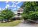 Two-story exterior with a balcony on each floor and a long driveway framed by lush trees at 1797 Olive Se St, Atlanta, GA 30315