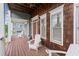 Inviting front porch with wooden flooring, white rocking chairs, and a charming, rustic design at 1797 Olive Se St, Atlanta, GA 30315