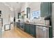 Modern kitchen featuring sleek, blue-gray cabinets, stainless steel appliances, and hardwood floors at 1797 Olive Se St, Atlanta, GA 30315