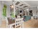 Open concept kitchen and dining area with coffered ceiling, island with seating, and stainless steel appliances at 1797 Olive Se St, Atlanta, GA 30315