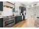 Stylish kitchen featuring stainless steel appliances, dark blue cabinets, subway tiles, and hardwood floors at 1797 Olive Se St, Atlanta, GA 30315