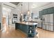 Modern kitchen featuring stainless steel appliances, granite countertops, a large island, and ample cabinet space at 1797 Olive Se St, Atlanta, GA 30315