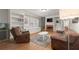 This living room has hardwood floors, recessed lights, brown sofas, a fireplace, and built-in shelves at 1797 Olive Se St, Atlanta, GA 30315