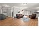 This living room has hardwood floors, recessed lighting, grey walls, and a brown sofa and recliner at 1797 Olive Se St, Atlanta, GA 30315