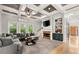 Spacious living room with a cozy fireplace, coffered ceilings, and large windows offering plenty of natural light at 1797 Olive Se St, Atlanta, GA 30315