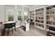 Well-lit home office with built-in bookshelves, a spacious desk, and large windows at 1797 Olive Se St, Atlanta, GA 30315
