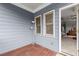 Covered patio with siding, lamp and doorway leading to interior at 1797 Olive Se St, Atlanta, GA 30315