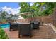 Outdoor pool and patio are framed by a wooden fence, tall pines, and lush landscaping at 1797 Olive Se St, Atlanta, GA 30315