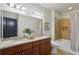 Bathroom with double sink vanity, granite countertops, a shower-tub combo, and modern fixtures at 201 W Ponce De Leon Ave # 13, Decatur, GA 30030