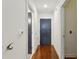 Narrow hallway with hardwood floors and neutral walls leading to other rooms in the house at 201 W Ponce De Leon Ave # 13, Decatur, GA 30030