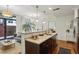 Bright kitchen with a view to outdoor patio; granite countertops, dark cabinetry, open living space at 201 W Ponce De Leon Ave # 13, Decatur, GA 30030