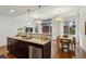 Open floor plan kitchen with granite countertops, stainless steel appliances, and eat-in dining area at 201 W Ponce De Leon Ave # 13, Decatur, GA 30030
