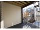 Balcony view overlooking neighboring townhomes, wood deck, and iron railing at 205 Midnight Oak Run # 5, Alpharetta, GA 30009