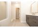 Modern bathroom with glass enclosed shower, gray vanity, and neutral tile flooring at 205 Midnight Oak Run # 5, Alpharetta, GA 30009