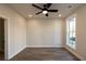 A cozy bedroom features an overhead fan, hardwood floors, and a bright window at 205 Midnight Oak Run # 5, Alpharetta, GA 30009