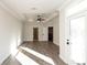 A sunlit bedroom featuring gray wood floors, a ceiling fan, and neutral wall paint at 205 Midnight Oak Run # 5, Alpharetta, GA 30009