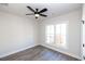 Bright bedroom features a ceiling fan, wood-look floors, and a large window at 205 Midnight Oak Run # 5, Alpharetta, GA 30009