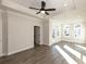 Bright bedroom with stylish ceiling fan, gray-toned floors and glass doors to a patio at 205 Midnight Oak Run # 5, Alpharetta, GA 30009