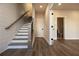 Entry hallway features hardwood flooring, stairs with white risers, and access to the bathroom at 205 Midnight Oak Run # 5, Alpharetta, GA 30009