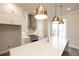 Bright kitchen features white cabinets, stainless steel appliances, granite countertops, and pendant lighting at 205 Midnight Oak Run # 5, Alpharetta, GA 30009