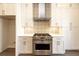 Close up of kitchen with stainless steel range, tile backsplash, and white cabinets at 205 Midnight Oak Run # 5, Alpharetta, GA 30009