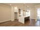 An open kitchen featuring quartz countertops, a large island, and stainless steel appliances at 205 Midnight Oak Run # 5, Alpharetta, GA 30009