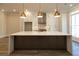Modern kitchen boasts a large island, stainless steel appliances, white cabinets, and stunning pendant lights at 205 Midnight Oak Run # 5, Alpharetta, GA 30009