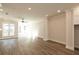 Expansive living room with hardwood floors, recessed lighting, and access to an outdoor balcony at 205 Midnight Oak Run # 5, Alpharetta, GA 30009