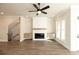 Cozy living room features a fireplace with built-in cabinets, a ceiling fan, and hardwood floors at 205 Midnight Oak Run # 5, Alpharetta, GA 30009